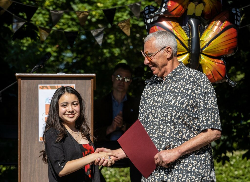 A student graduating from the class of 2026 at The Meridian School shakes the Head of School's hand.