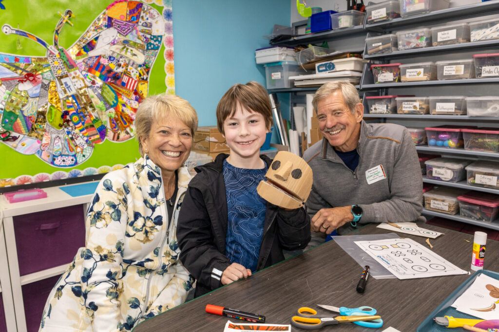 A student works on a project in The Meridian School's creativity lab with his grandparents