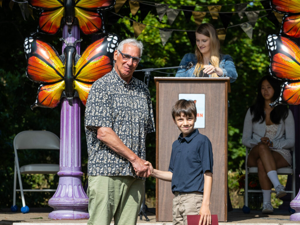 Student shakes hands at graduation.