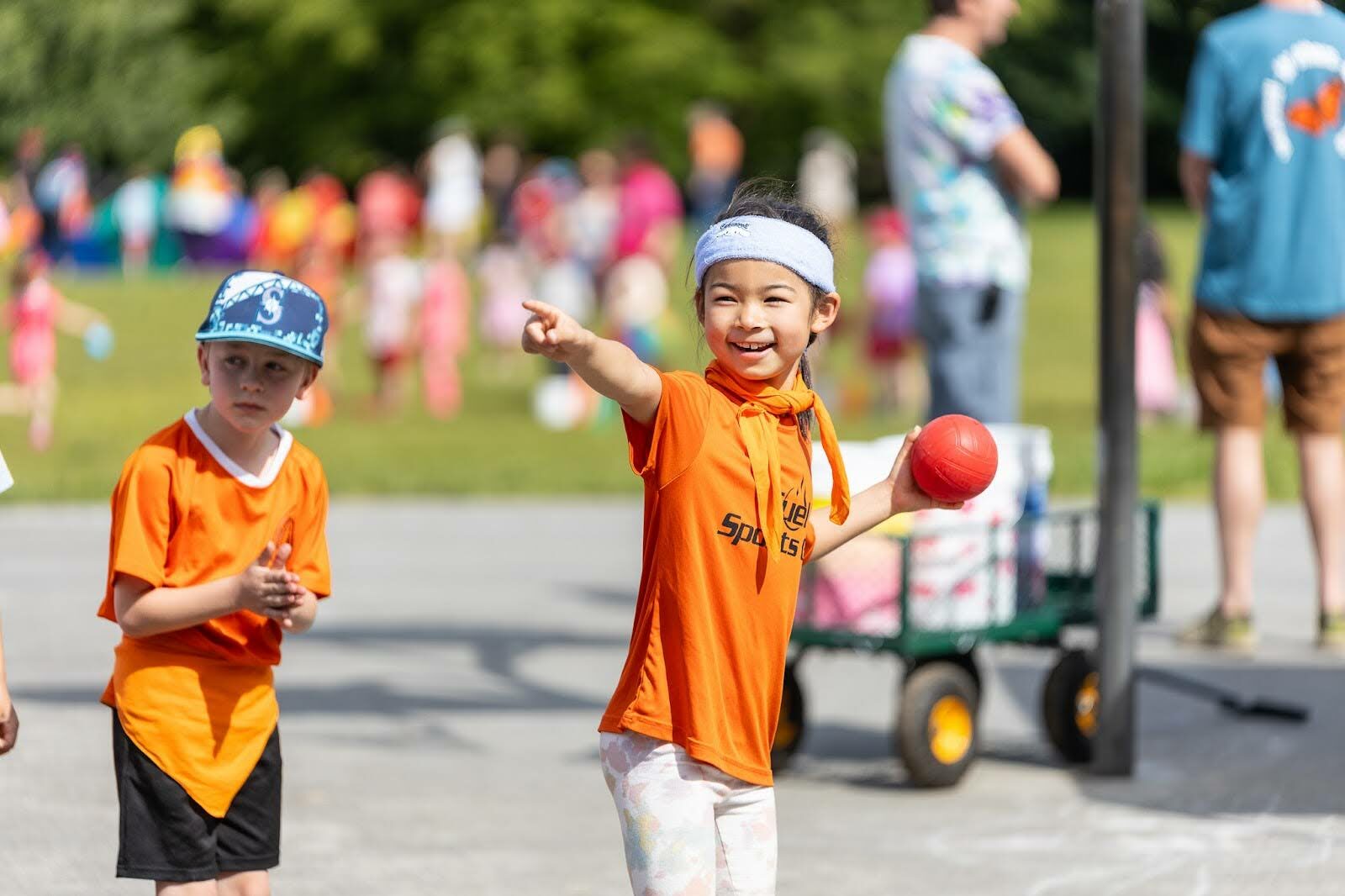 student outside with red ball