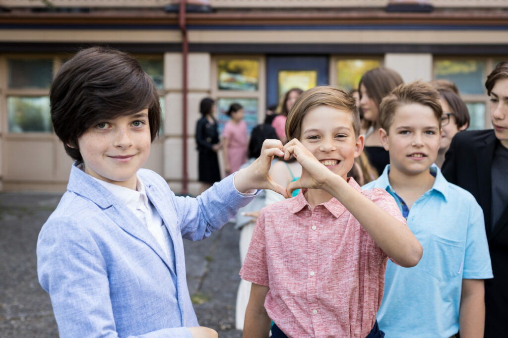 students together holding hands making heart