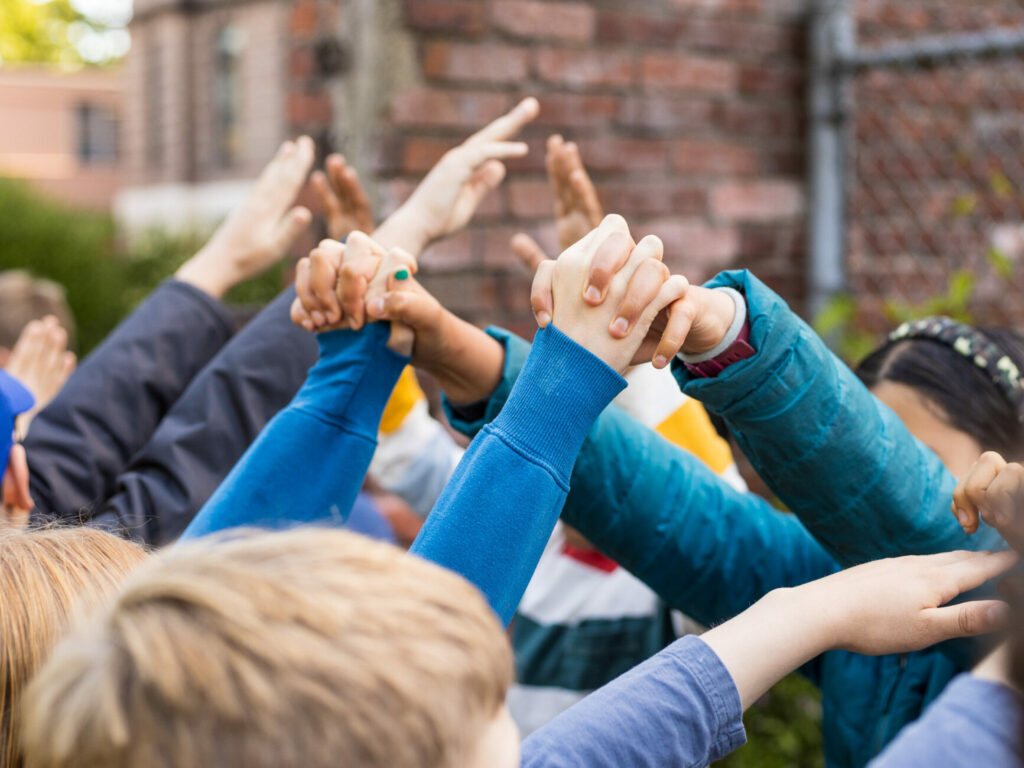 Students holding hands for the graduation tunnel