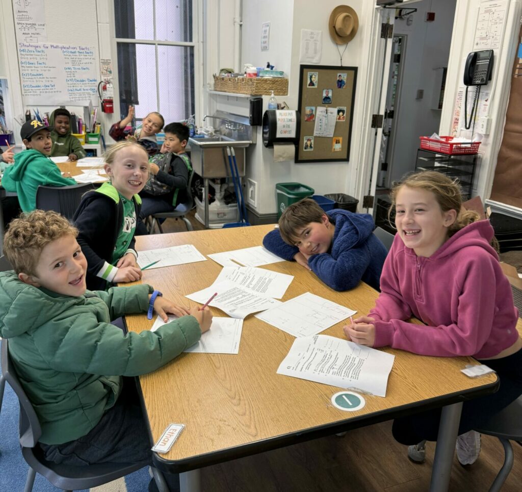 Students studying together around a desk