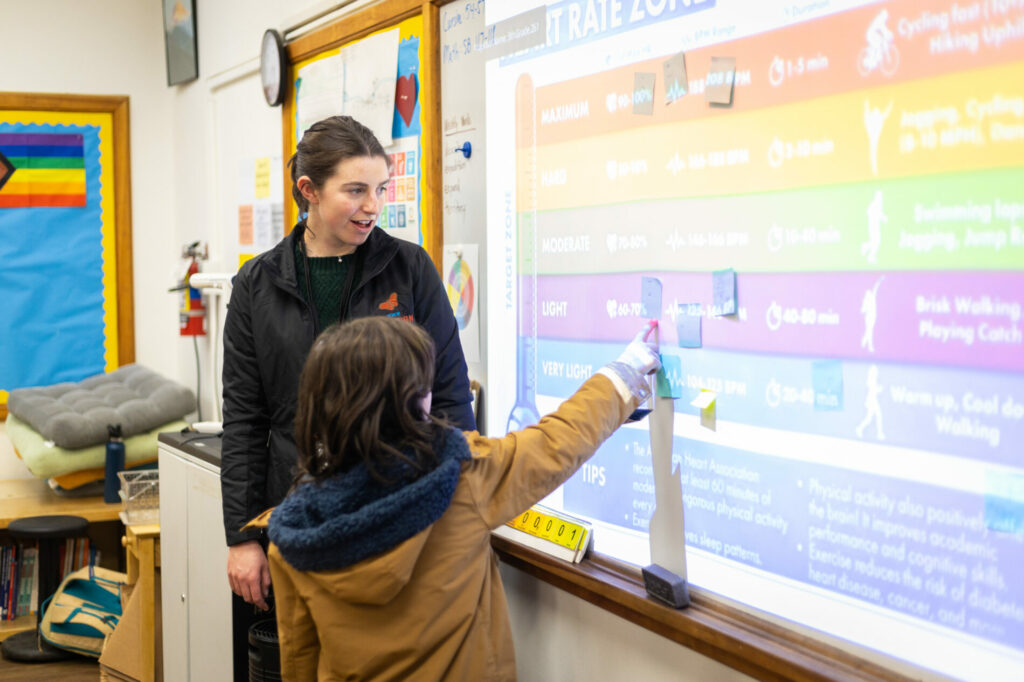 teacher with student at front board