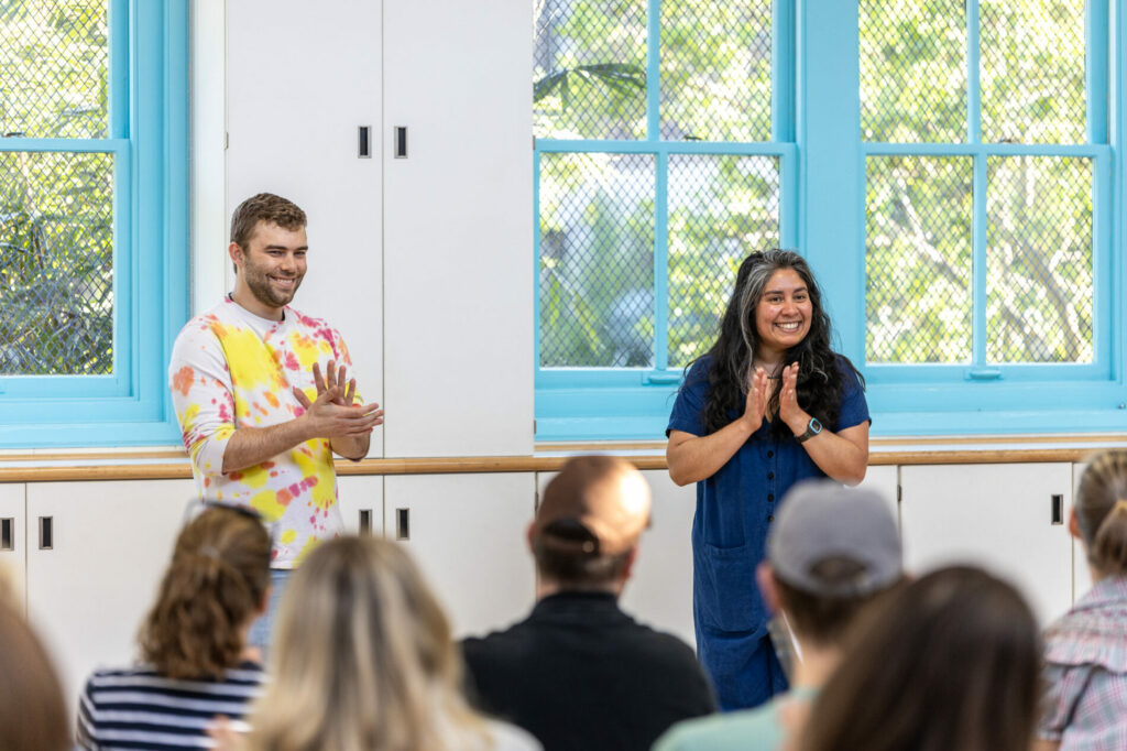 Teachers clap after a student presentation