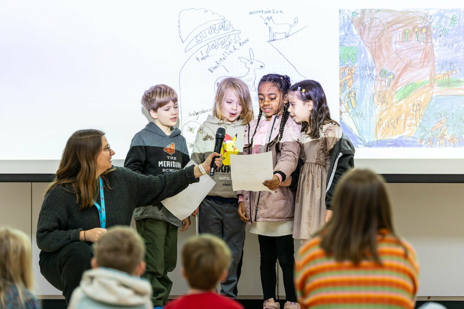 students reading at front of class