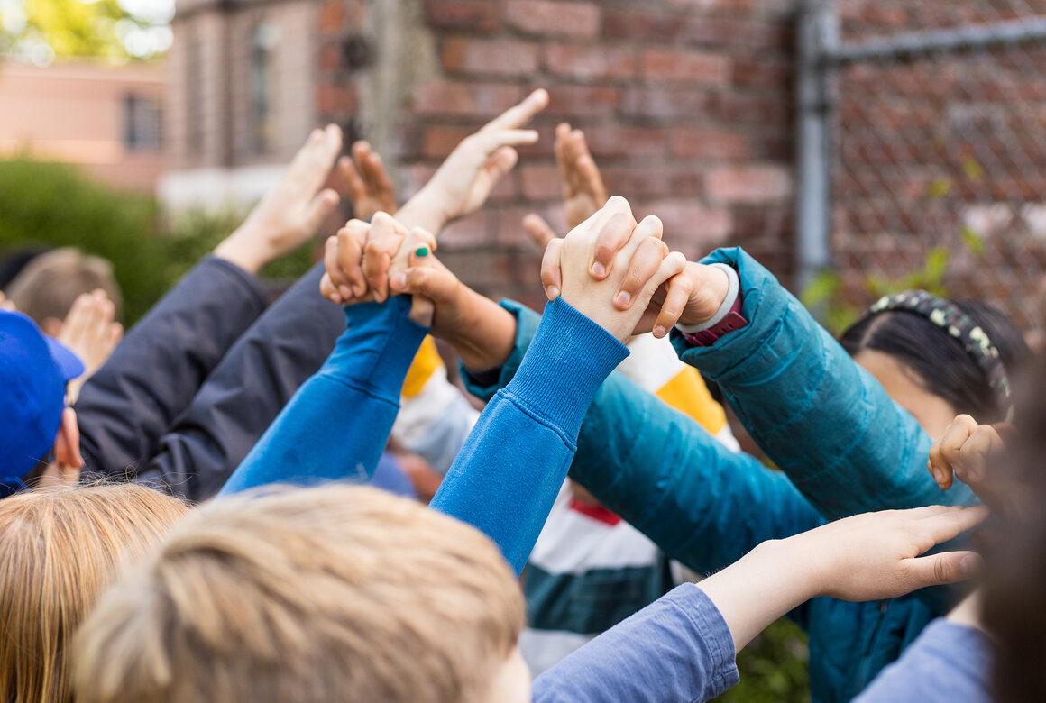 students holding hands