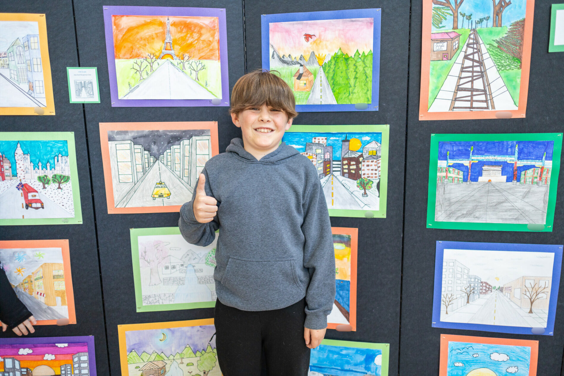 students standing in front of wall art