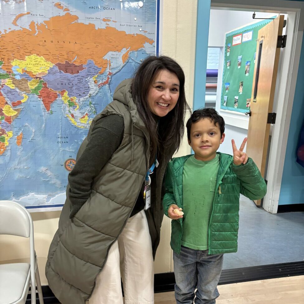A student poses with the school psychologist.