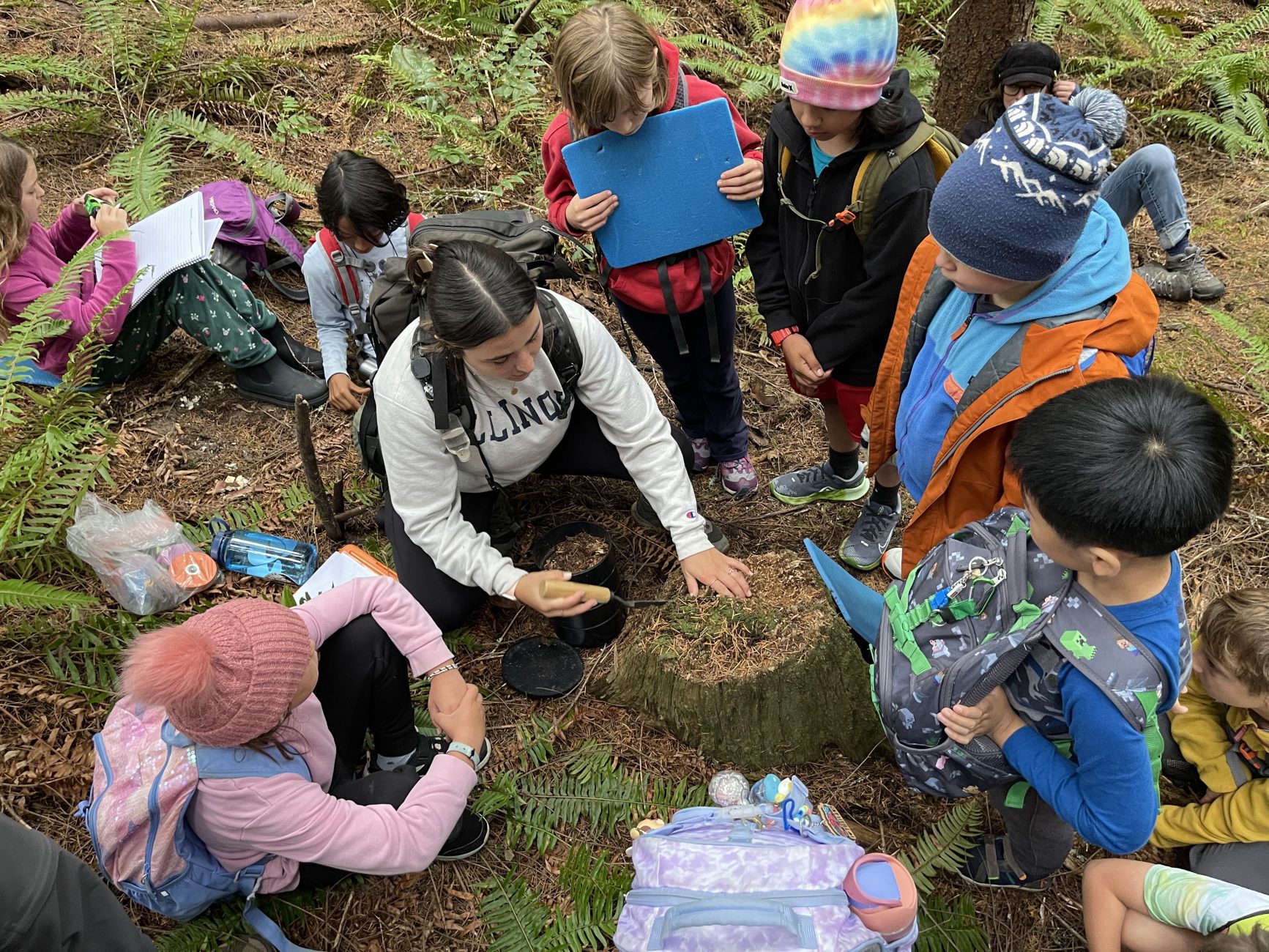 students outside looking at tree moss