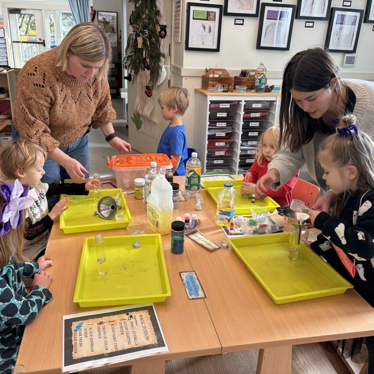 Teachers guide students during an art project