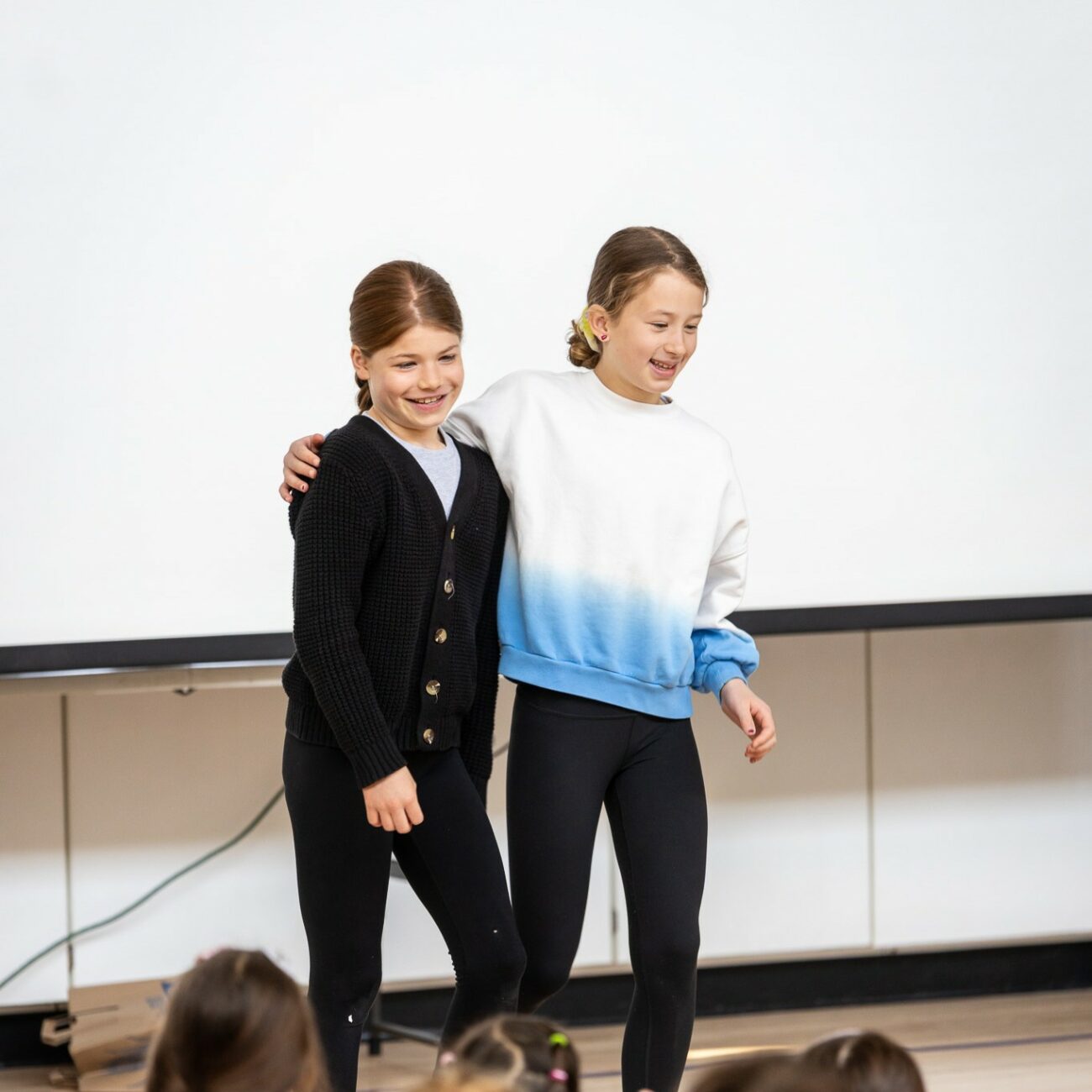 A pair of students finish a synchronized routine.