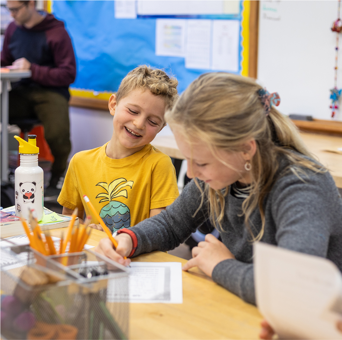 teacher with student at desk
