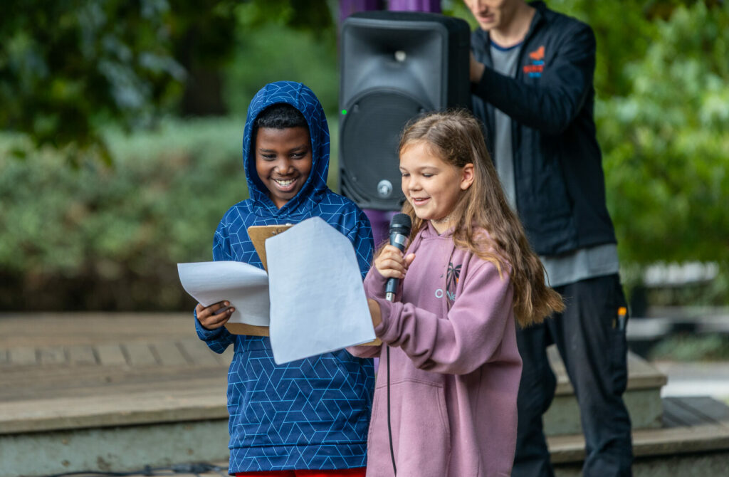 Two Meridian School students present at an all school assembly at Meridian Playground by The Good Shepherd Center in Seattle, Washington.
