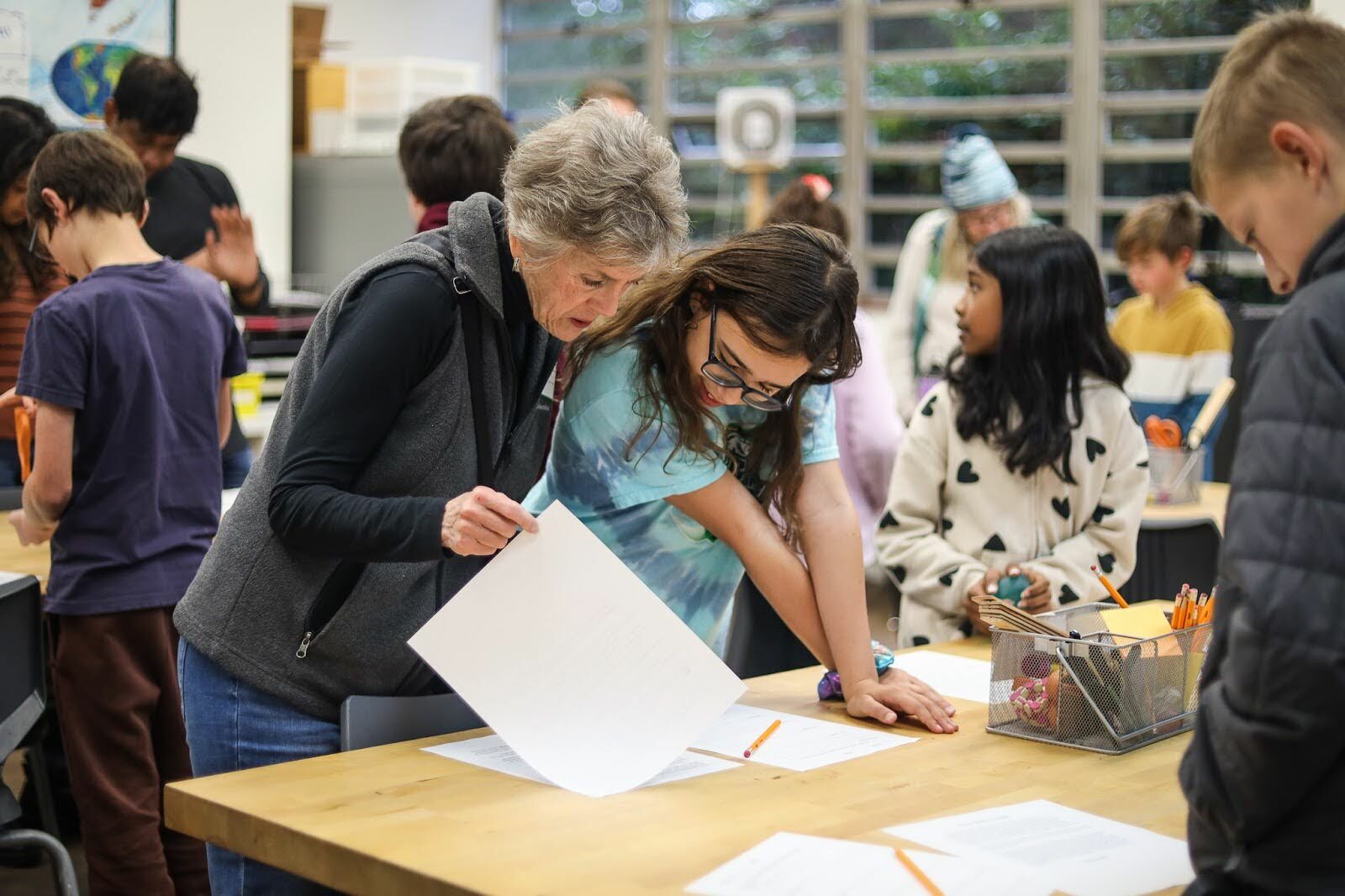 teachers and students around table