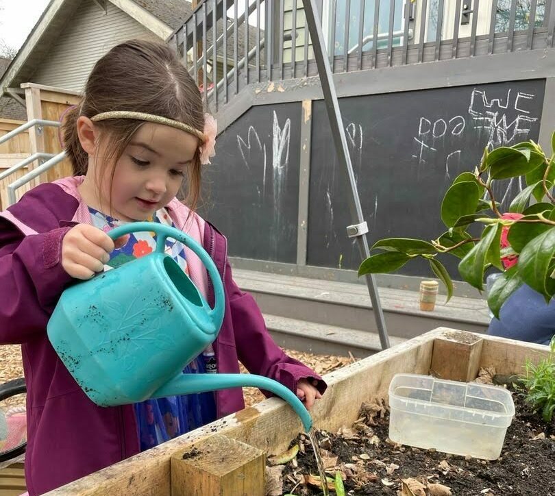 student watering plants